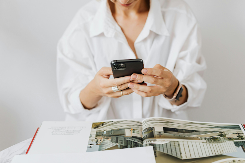 Woman photographing magazine | Does Social Media Help You Rank on Google? The Honest Answer for Interior Designers