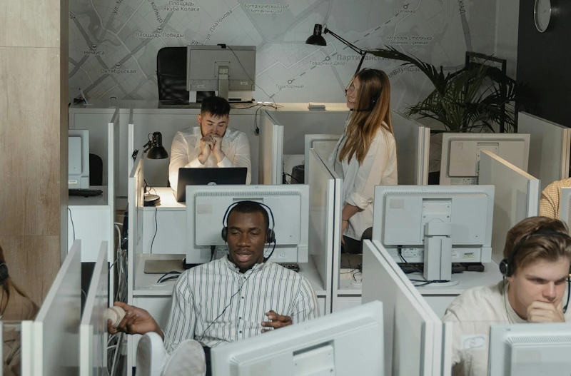 Office room with people and white computers in modern settings